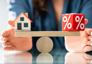 balancing scales with a house and a percentage sign