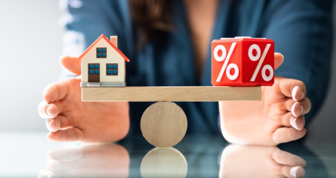 balancing scales with a house and a percentage sign