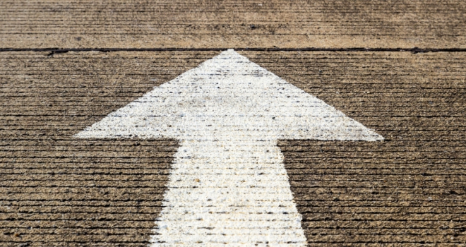 white arrow painted on concrete